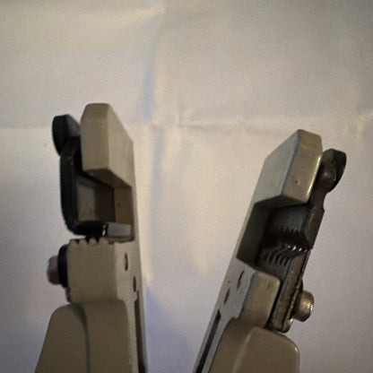 Beige and black electrical wire stripper tool type B with textured grip