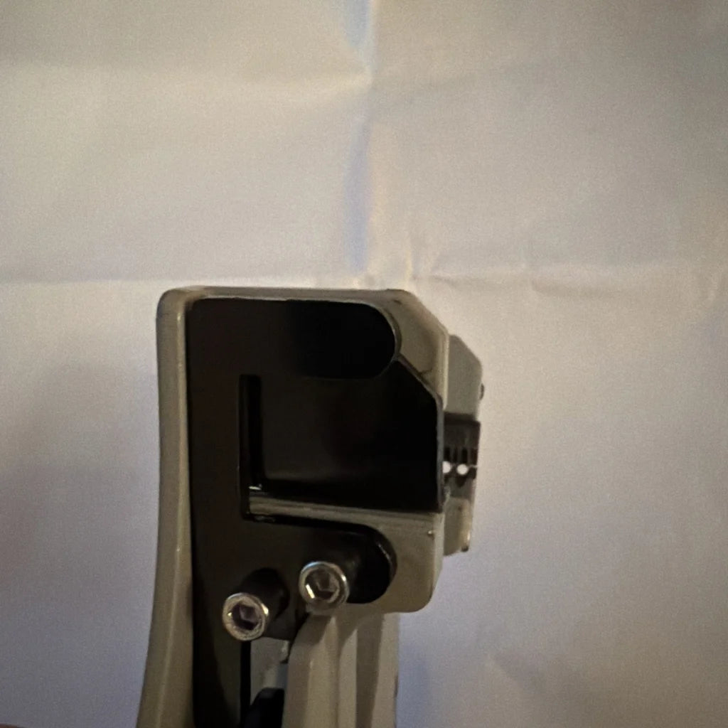 Back of gray plastic electrical wire stripper tool Type B with black interior and silver screws