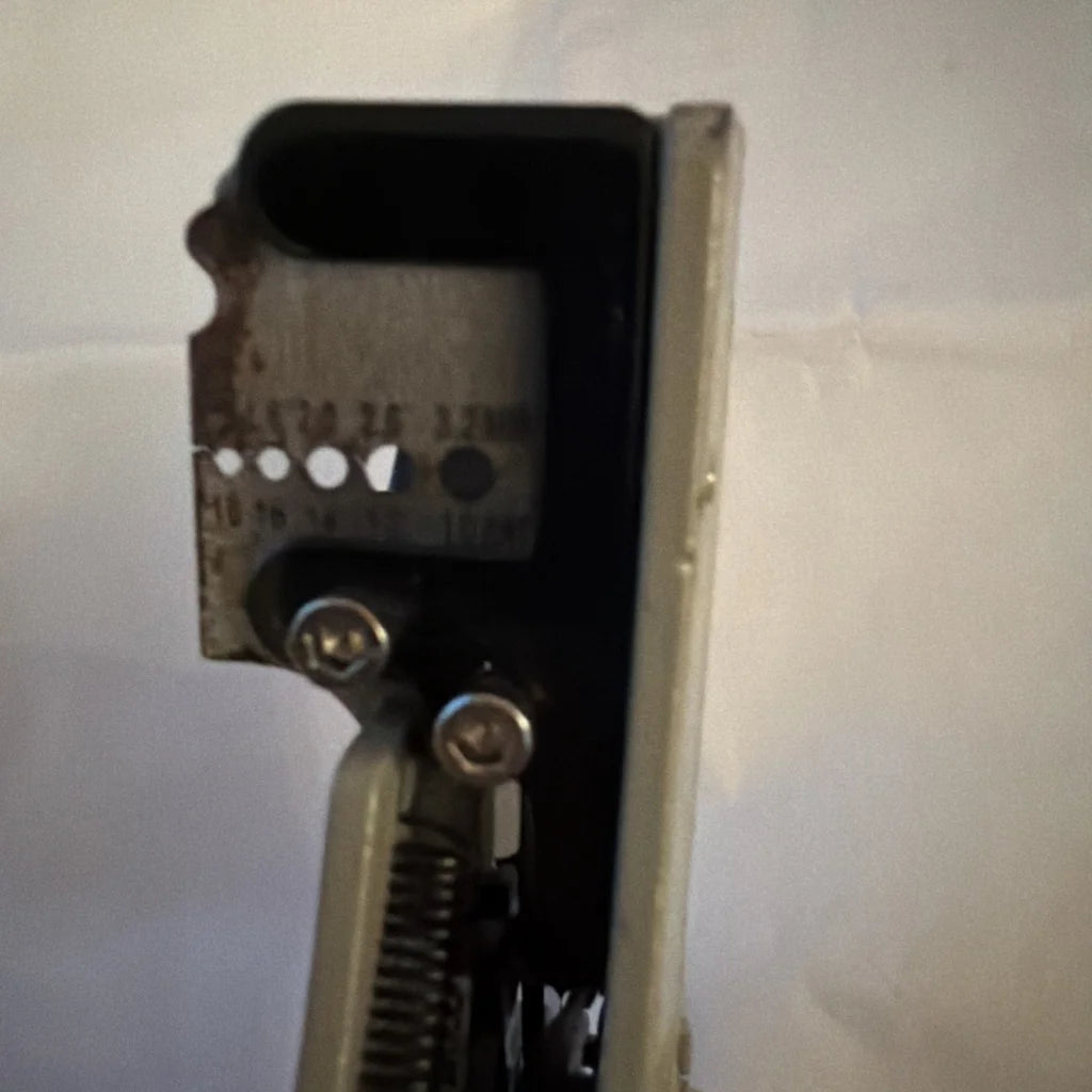 Rusty back of electrical wire stripper tool type B with screws and spring
