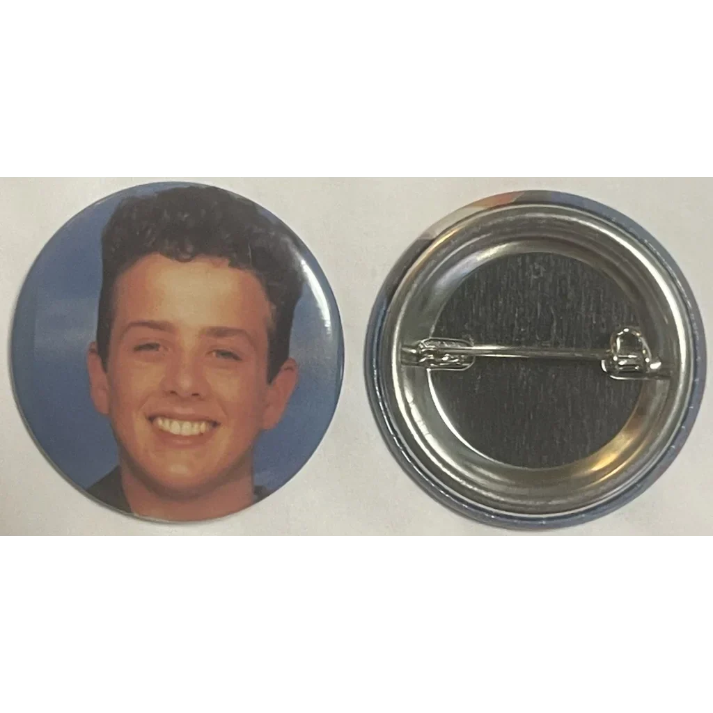 Circular button with a smiling young man’s portrait from iconic boy band New Kids on the Block