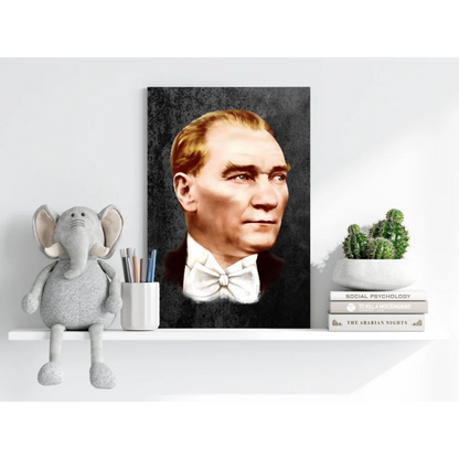Gray elephant plush toy with floppy ears and trunk on Atatürk portrait shelf