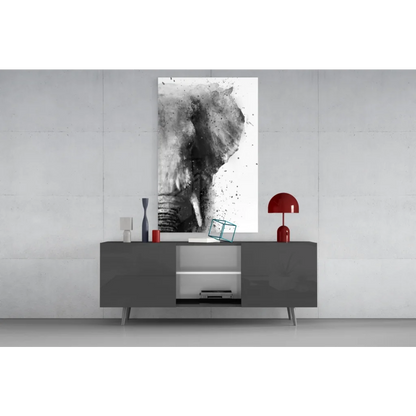 Abstract black and white elephant glass wall art above gray console