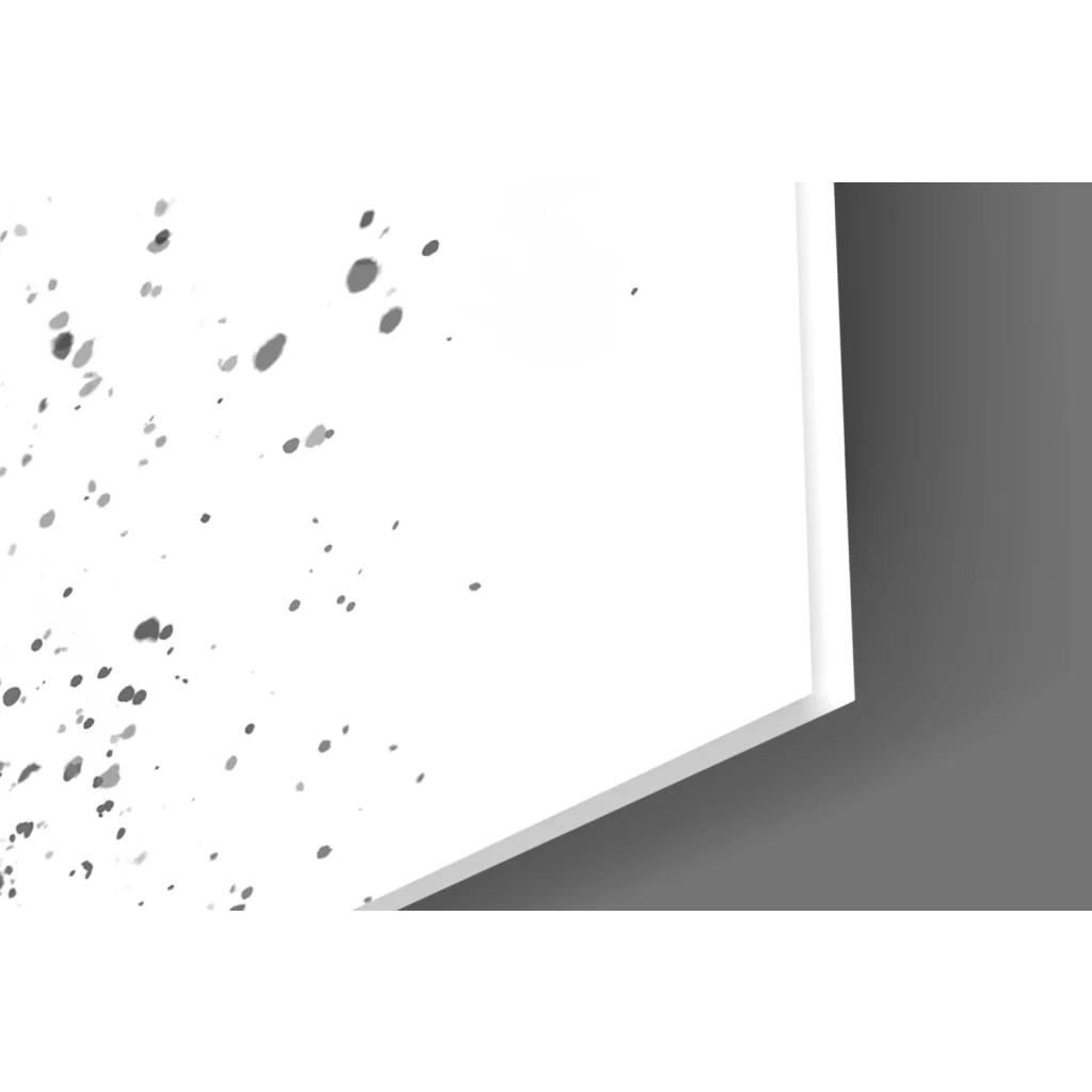 White rectangular glass wall art with black paint splatters on left side