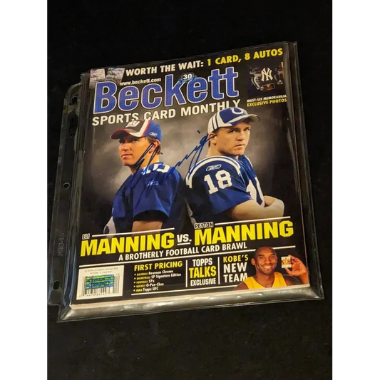 Eli Manning autographed Beckett Price Guide with Manning brothers on the cover in plastic sleeve