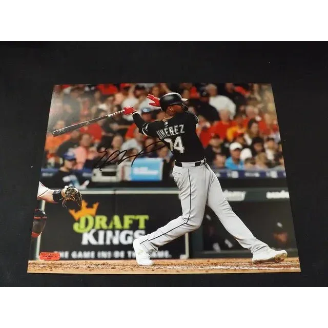 Eloy Jimenez signed 8x10 photo of him hitting a ball in black and white uniform