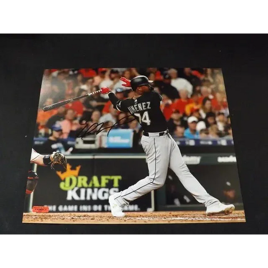 Eloy Jimenez signed 8x10 photo of him hitting a ball in black and white uniform