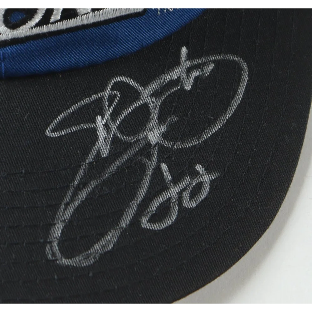 Black Dallas Cowboys cap signed by Emmitt Smith in a display case