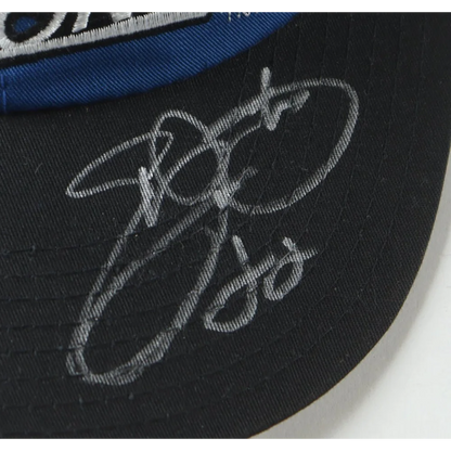 Black Dallas Cowboys cap signed by Emmitt Smith in a display case