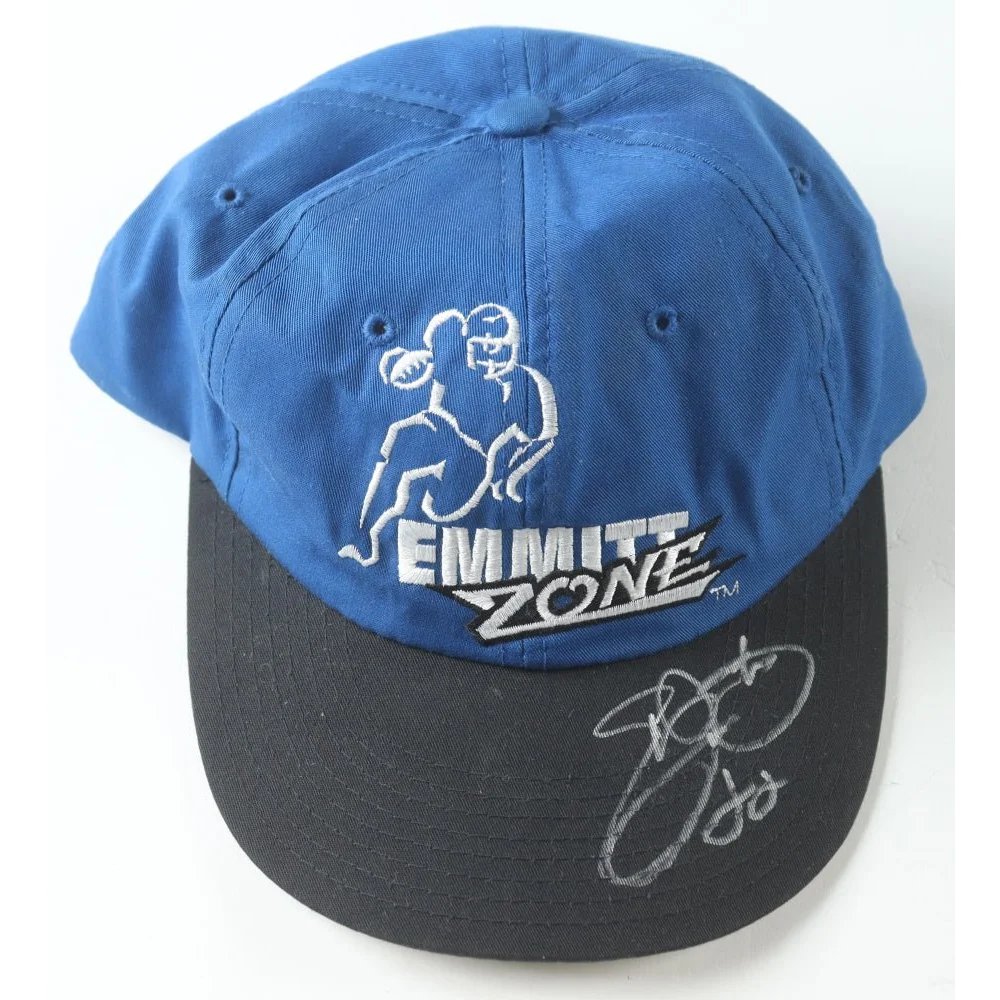 Blue and black Dallas Cowboys cap signed by Emmitt Smith in a display case