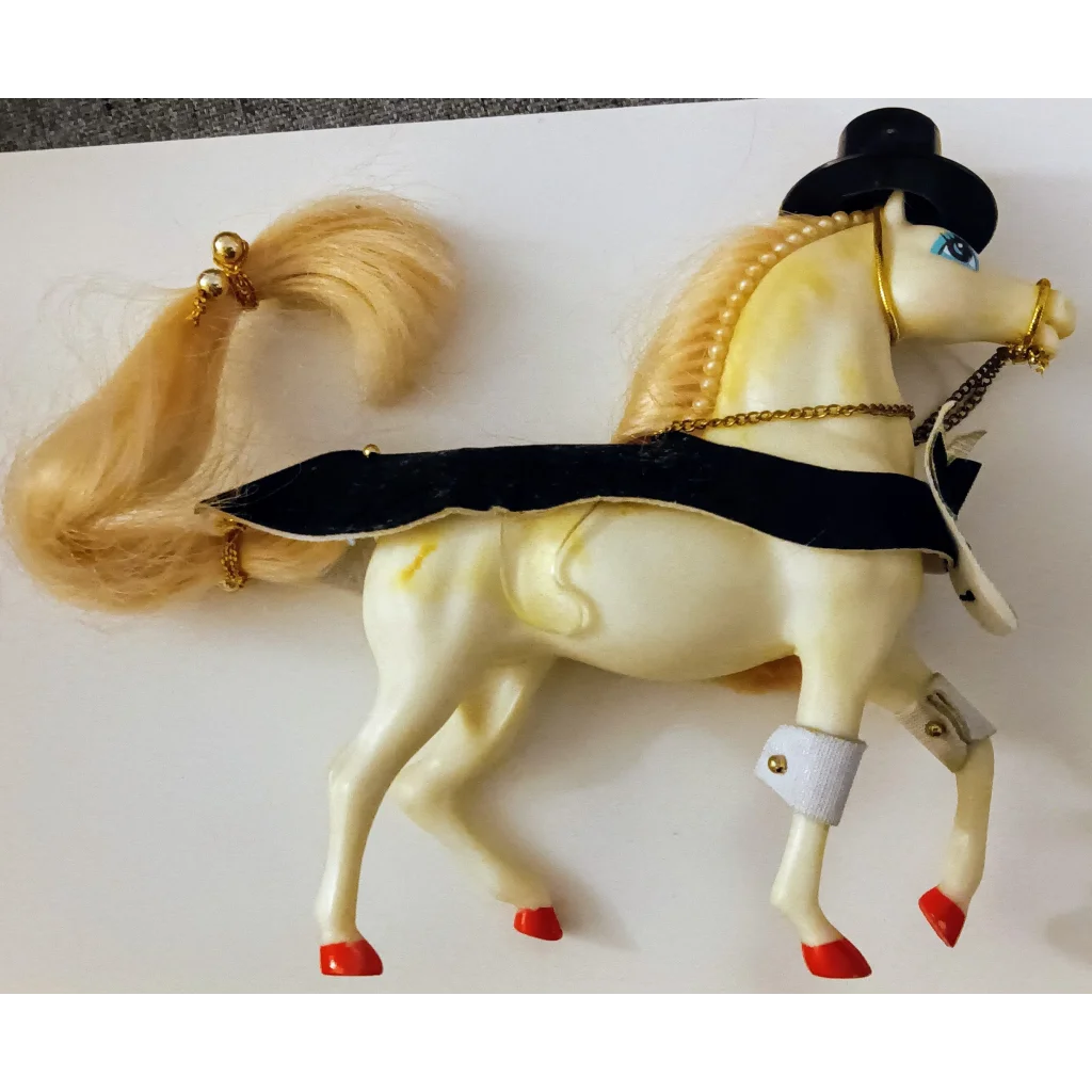 Enchanted kingdom horse figurine with cream body, black gold accents, pearl necklace, red hooves, blonde mane, and top hat