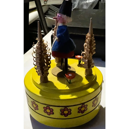 Yellow Reuge music box with Pinocchio figure playing timeless melodies