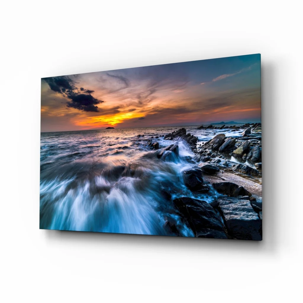 Vibrant sunset ocean glass wall art print with crashing waves on rocks
