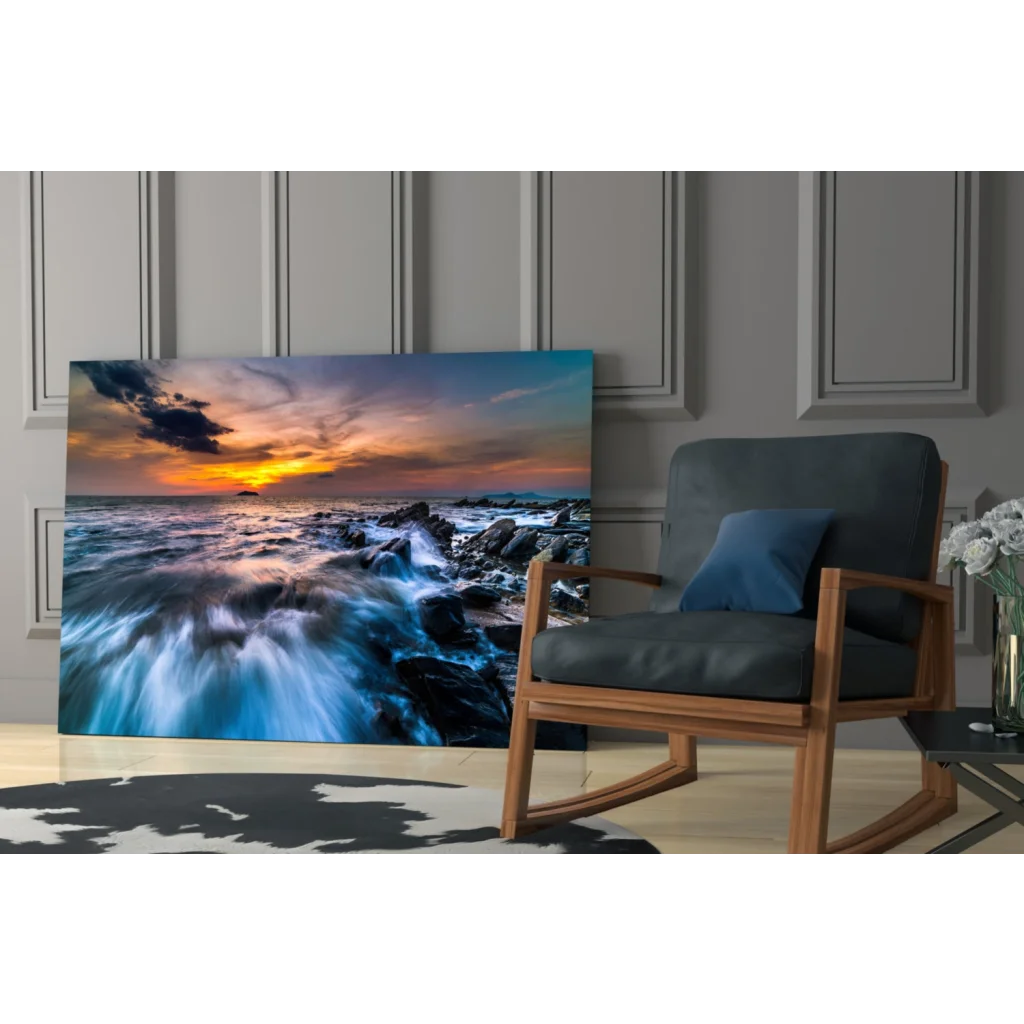 Vibrant sunset ocean glass wall art with crashing blue waves on rocks