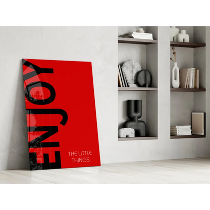 Vibrant red enjoy the little things canvas wall art leaning on white wall