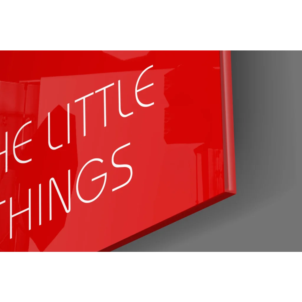Glossy red glass wall art sign reading Enjoy the Little Things