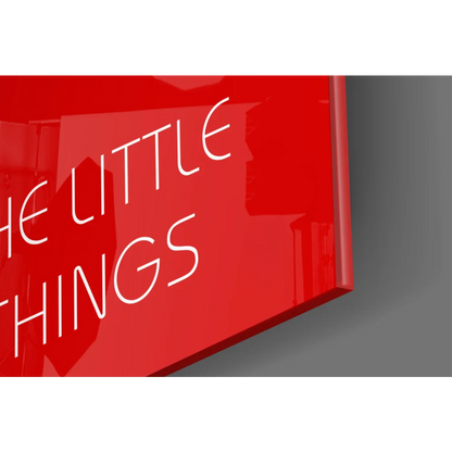Glossy red glass wall art sign reading Enjoy the Little Things