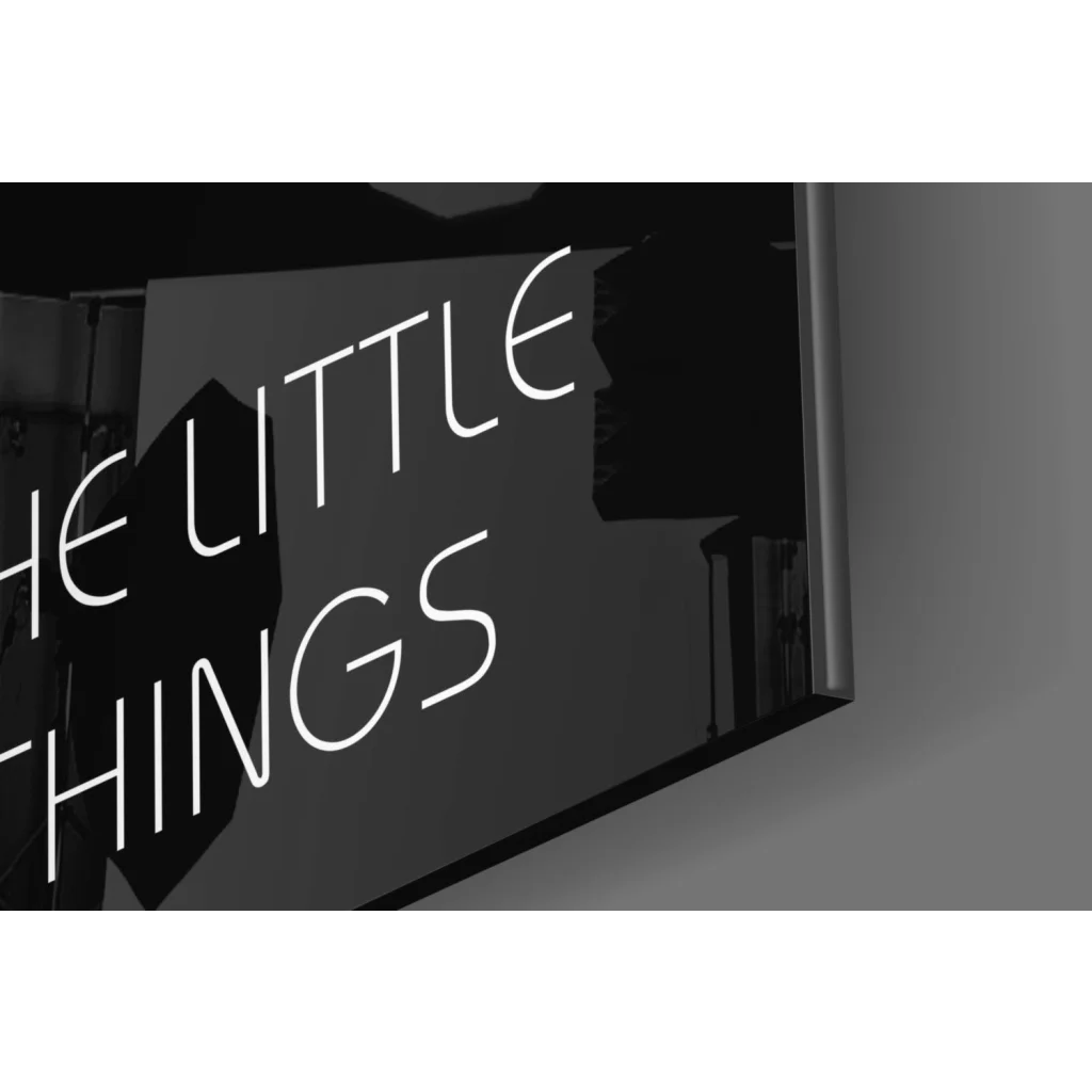 Sleek black sign with Enjoy The Little Things white lettering wall art