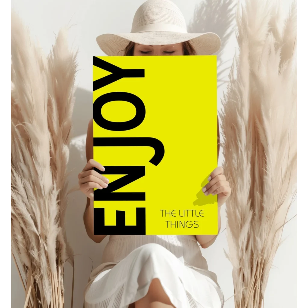 Woman in white hat reading Enjoy the Little Things yellow book wall print