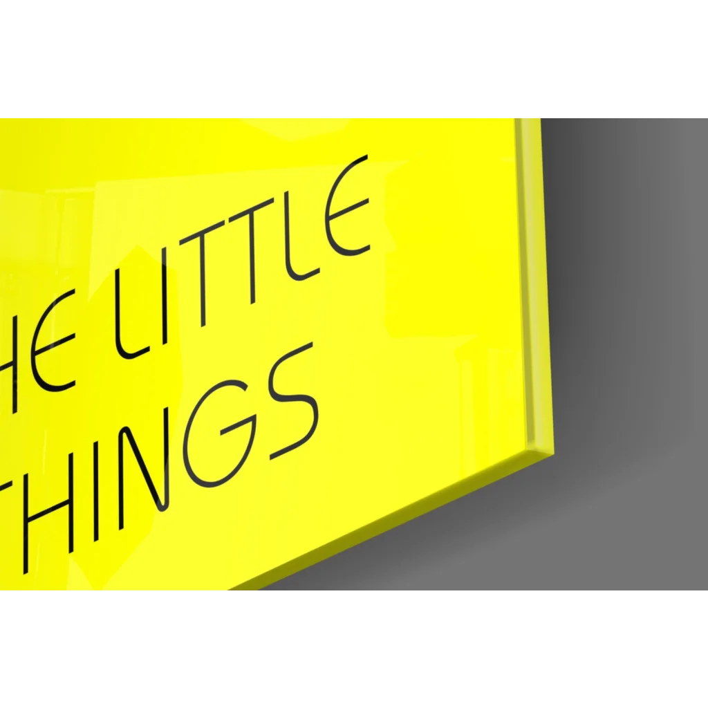 Bright yellow framed wall art with black text Enjoy The Little Things