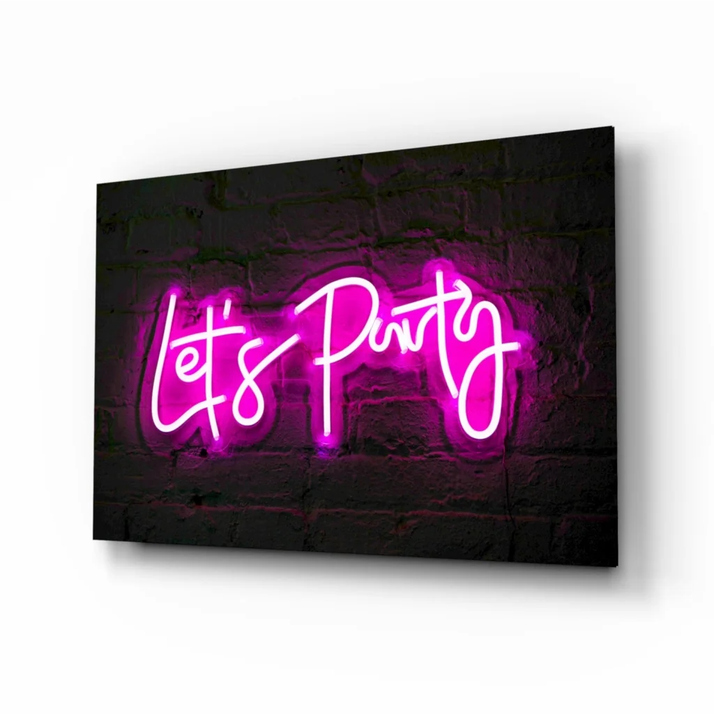 Vibrant pink neon lets party glass wall art sign on brick wall