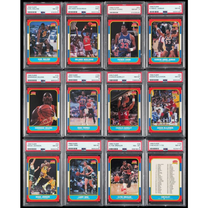 A collection of twelve graded Fleer NBA basketball cards from 1986 in Epic Fleer box