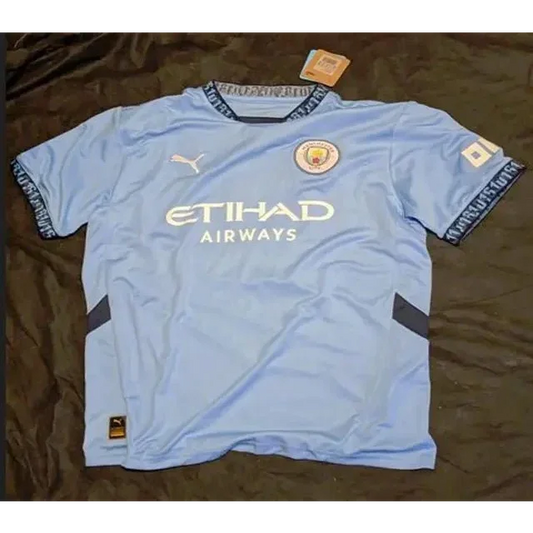 Light blue Manchester City autographed jersey shirt with dark blue accents featuring Erling Braut