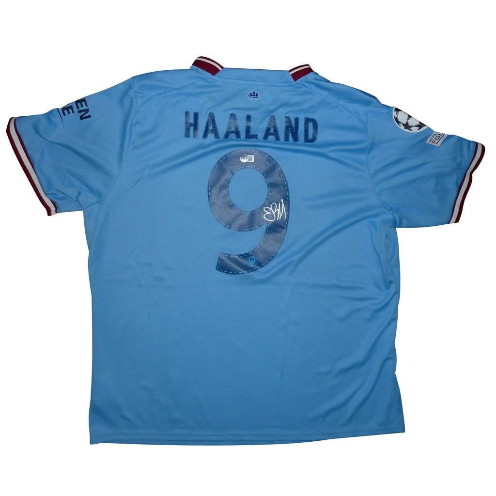 Back of light blue manchester city ethihad 2022-23 soccer jersey with erling haaland autographed name number 9 and beckett witness