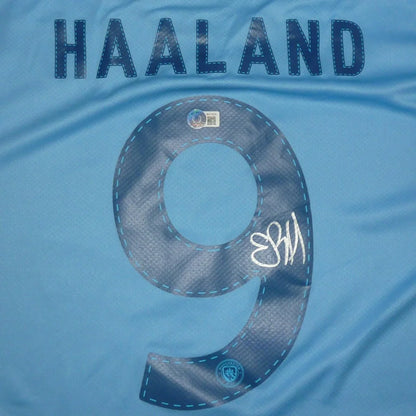 Back of light blue manchester city ethiad soccer jersey featuring erling haaland autographed name and number 9 with beckett witness