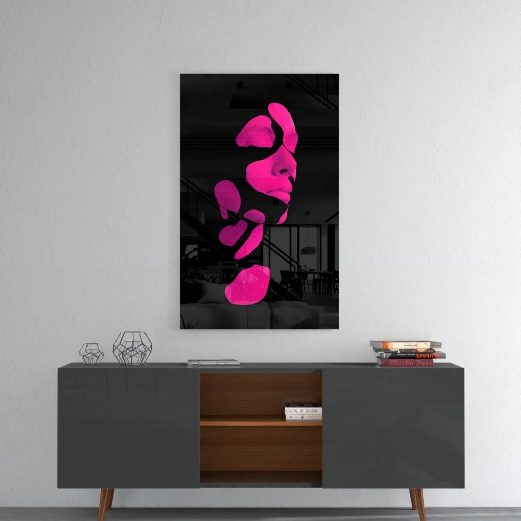 Vibrant pink abstract face glass wall art on gray console
