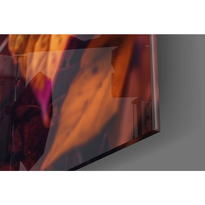 Sleek glass wall art with autumn leaves in orange purple hues