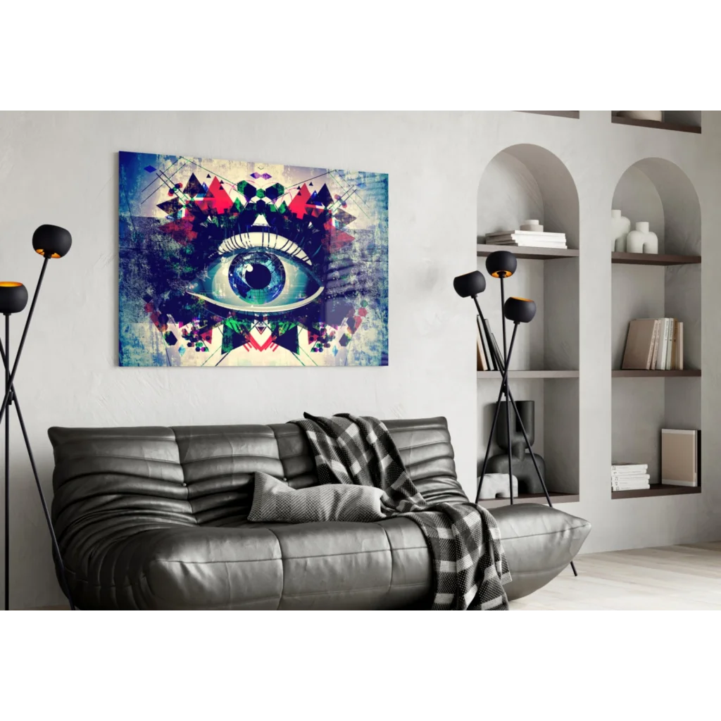 Vibrant geometric eye wall art canvas with blue iris and red green patterns above black sofa