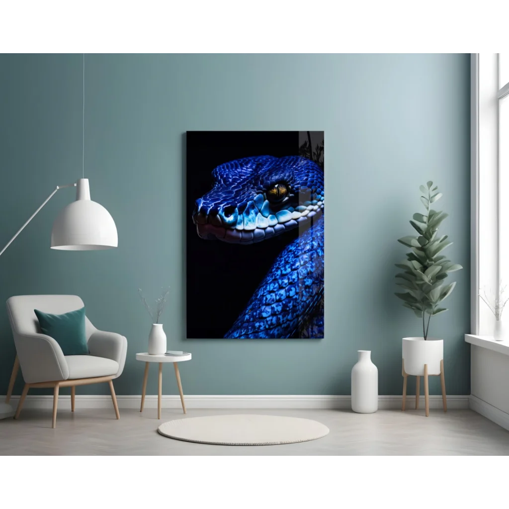 Vibrant blue snake glass wall art with golden eye on teal wall