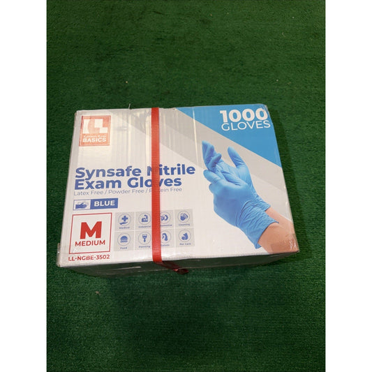 Sealed box of Synsafe blue nitrile exam gloves on green surface, showing front packaging with product image and red elastic band.
