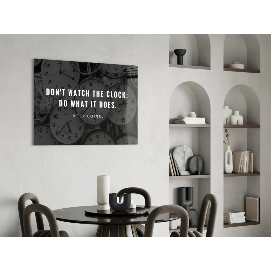 Black and white glass wall art with overlapping clocks and motivational quote
