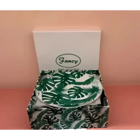 Open box of Fancy Home Collection dessert plates with green Monstera leaf patterns