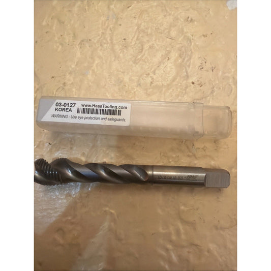 Haas Tooling thread tap tool 03-0127 displayed next to its clear plastic packaging on a beige textured surface.
