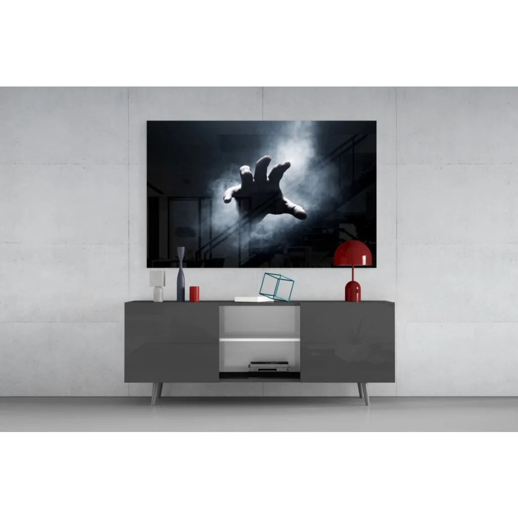 Black-and-white reaching hand through mist wall art on gray console