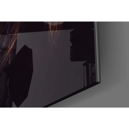 Fearless Lion glass wall art with sleek black-framed monitor showing dark silhouettes and orange sparks