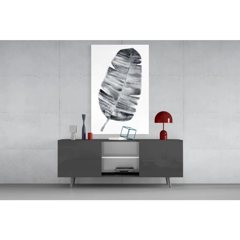 Modern black-and-white banana leaf wall art above gray console