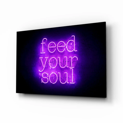 Glowing purple neon Feed Your Soul glass wall art sign on black background
