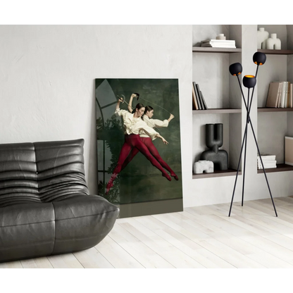 Vibrant glass wall art of two women fencing in cream tops and red pants