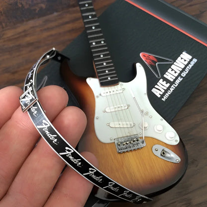 Axe Heaven mini guitar with Fender logo strap and sunburst finish