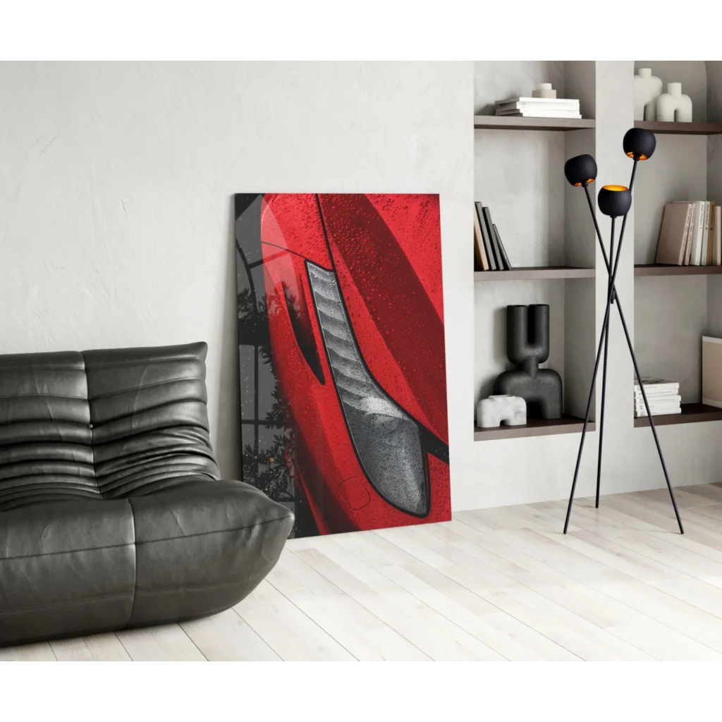 Bold red and black abstract glass wall art of stylized car headlight
