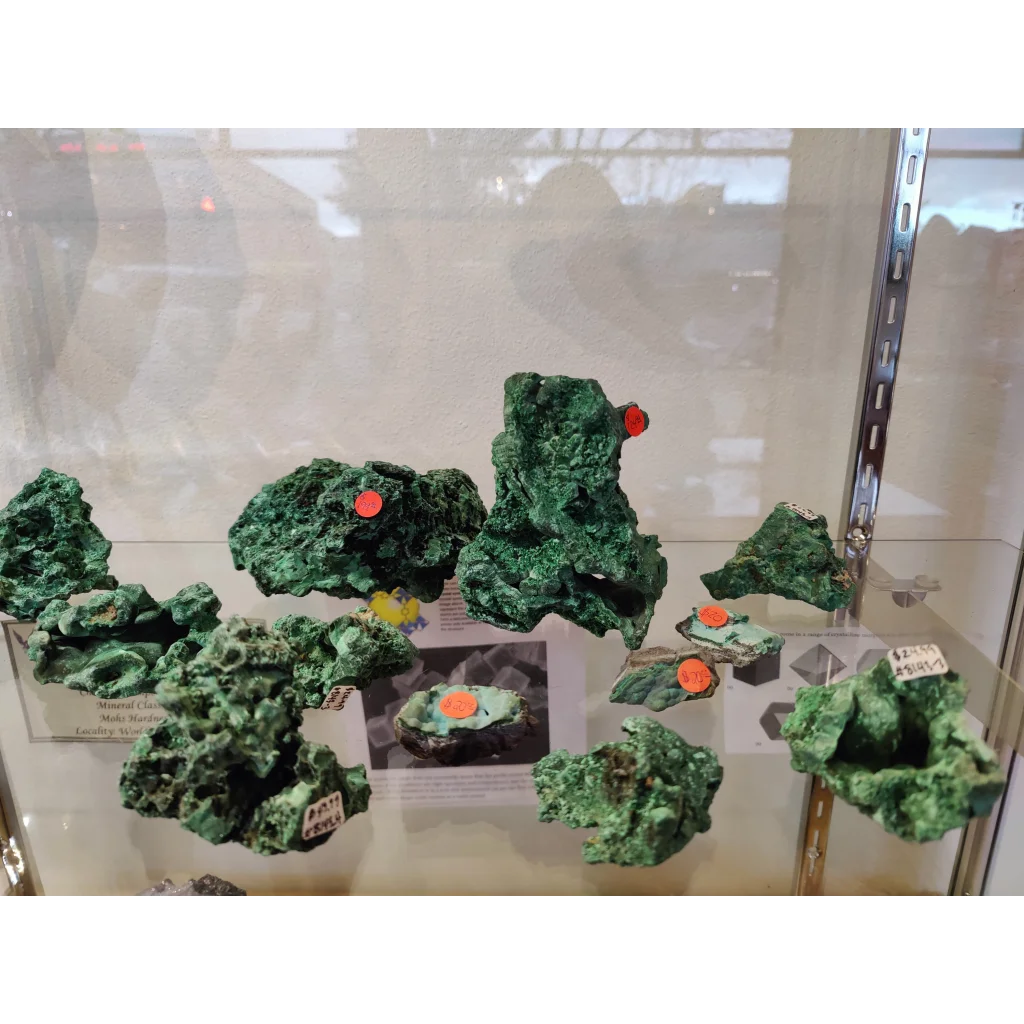 Fibrous velvet malachite specimens with green rough texture and orange tags