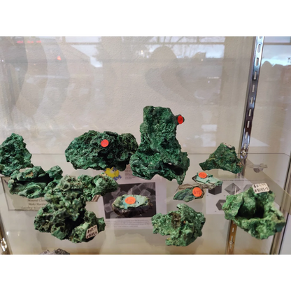 Fibrous velvet malachite specimens with green rough texture and orange tags