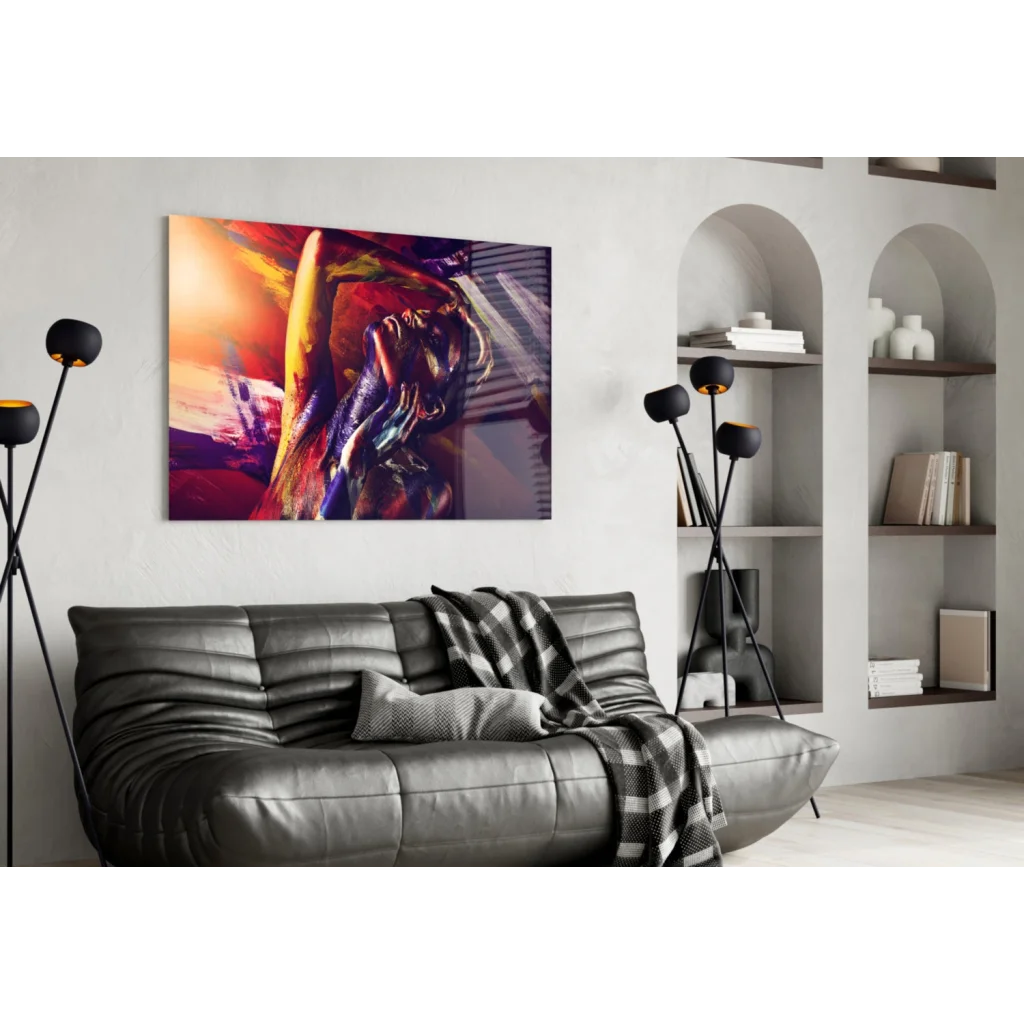 Fiery abstract canvas wall art in bold red, orange, purple swirls above black leather sofa