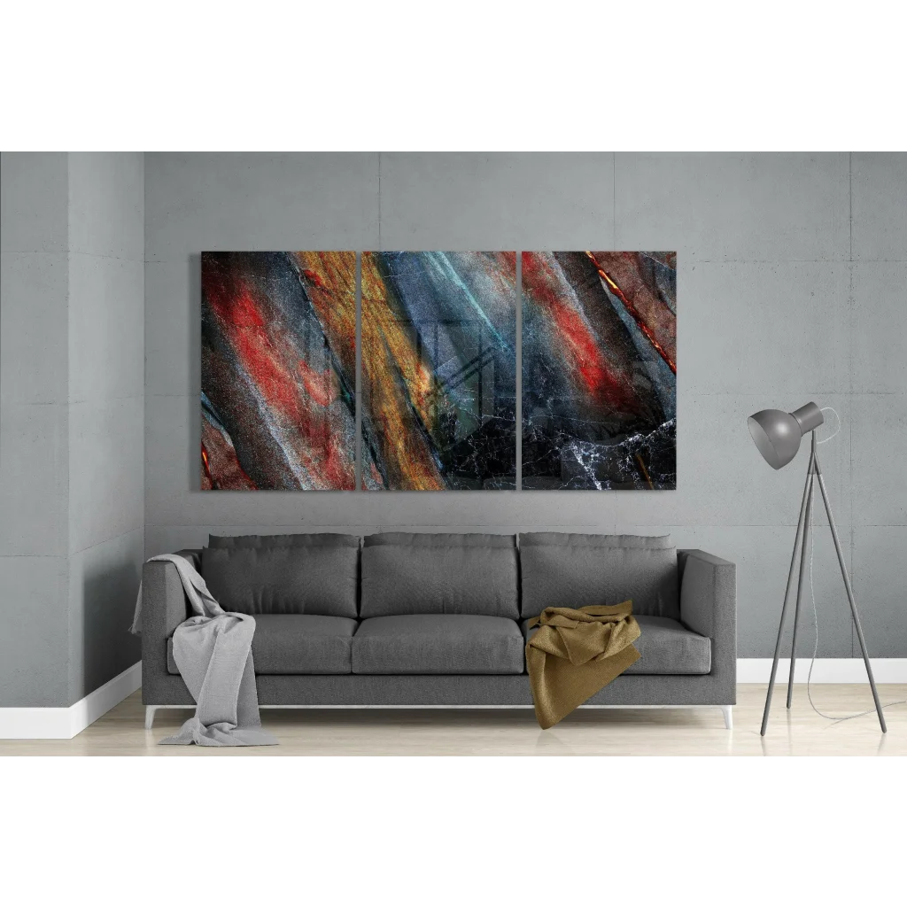 Fiery abstract triptych glass wall art with red, orange, blue streaks on black marble
