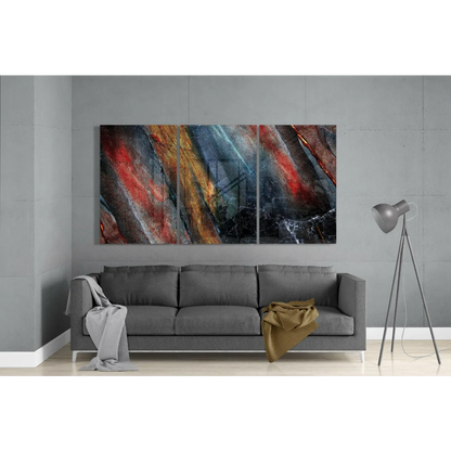 Fiery abstract triptych glass wall art with red, orange, blue streaks on black marble