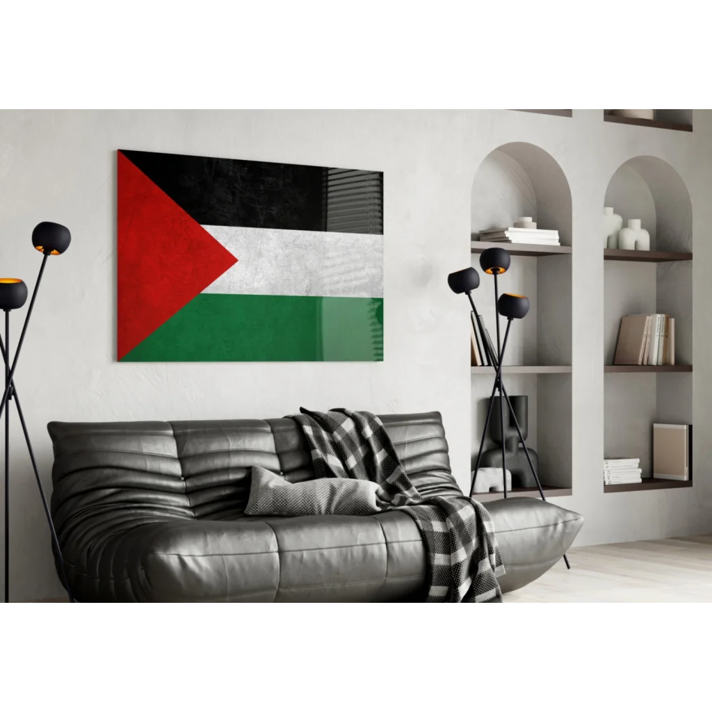 Modern black leather sofa with plaid blanket and Palestinian flag wall art