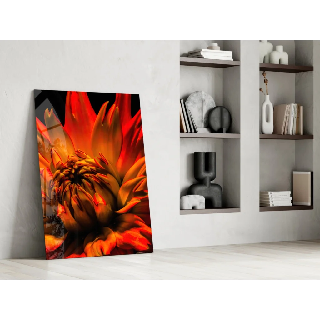 Vibrant orange red dahlia glass wall art print leaning on white wall